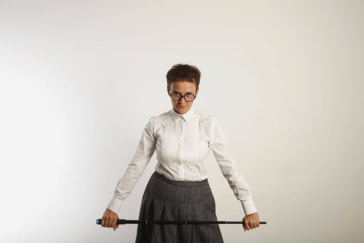 angry female teacher looking like she's ready to dish out some punishment