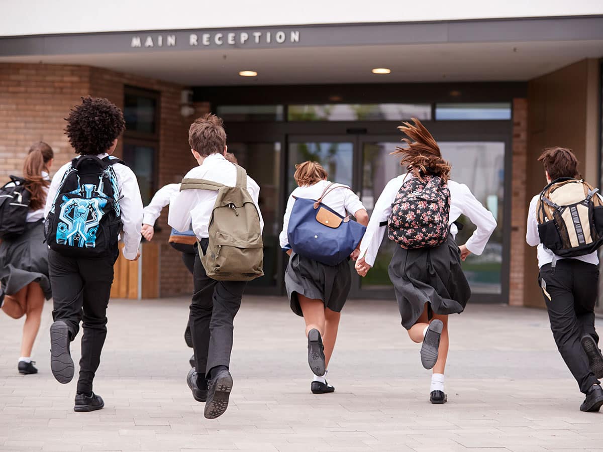 children running to school armed with excuses for wearing the wrong uniform