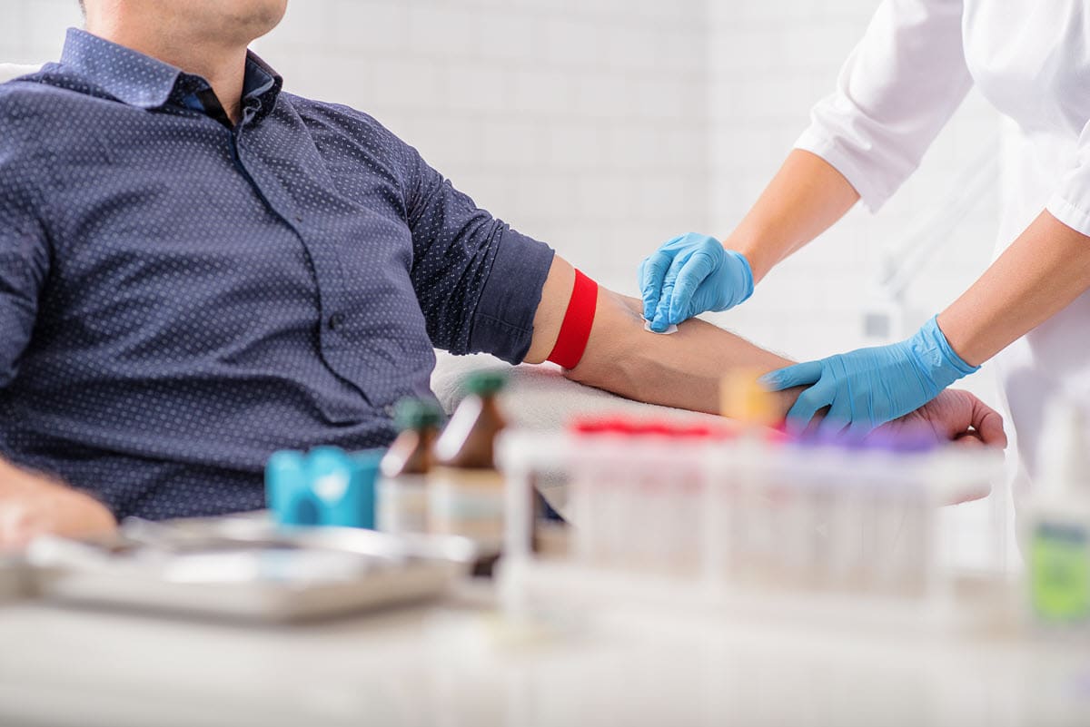 man donating blood to red cross