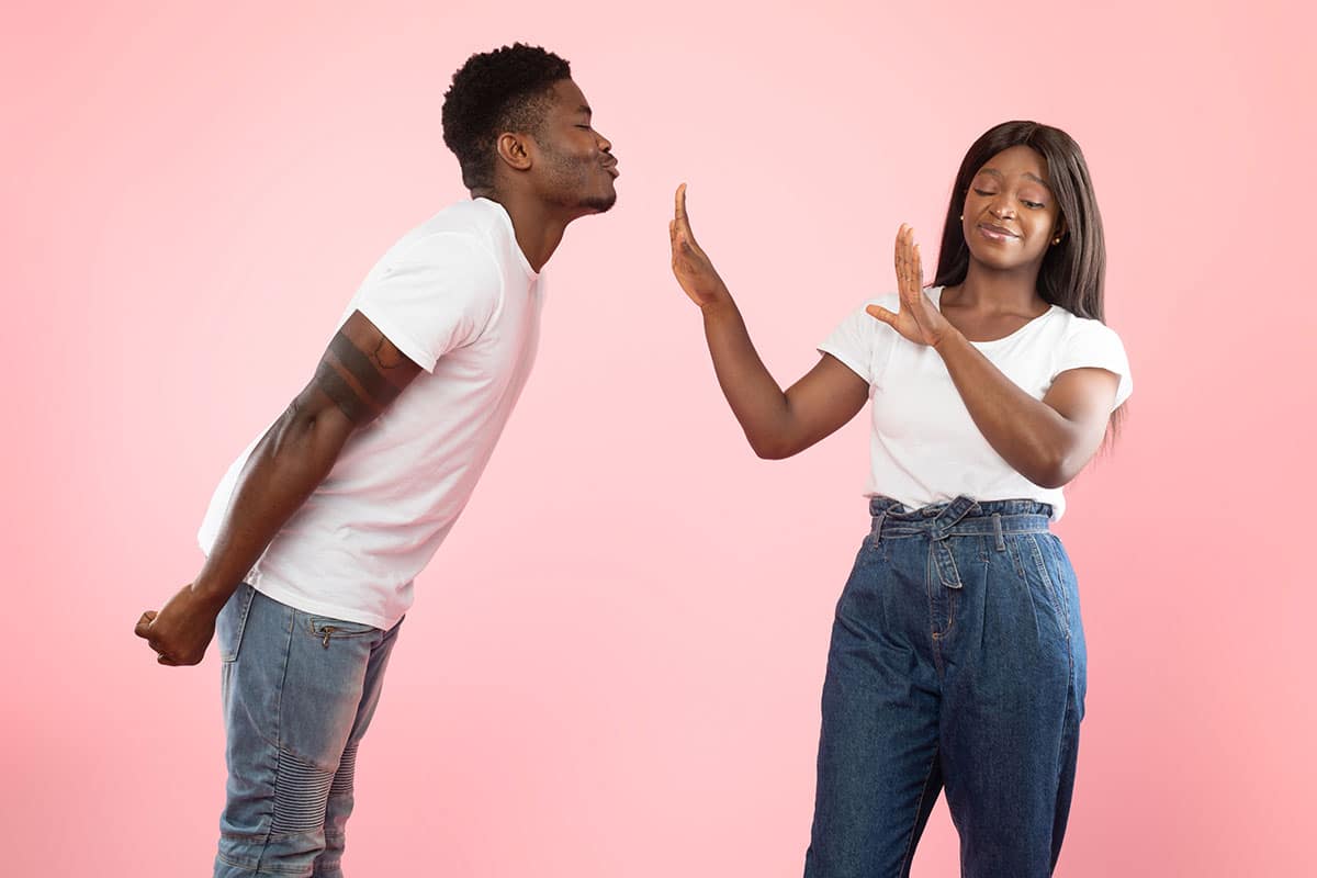 her boyfriend is leaning in for a kiss but she's put her hands up and is making excuses not to kiss your boyfriend