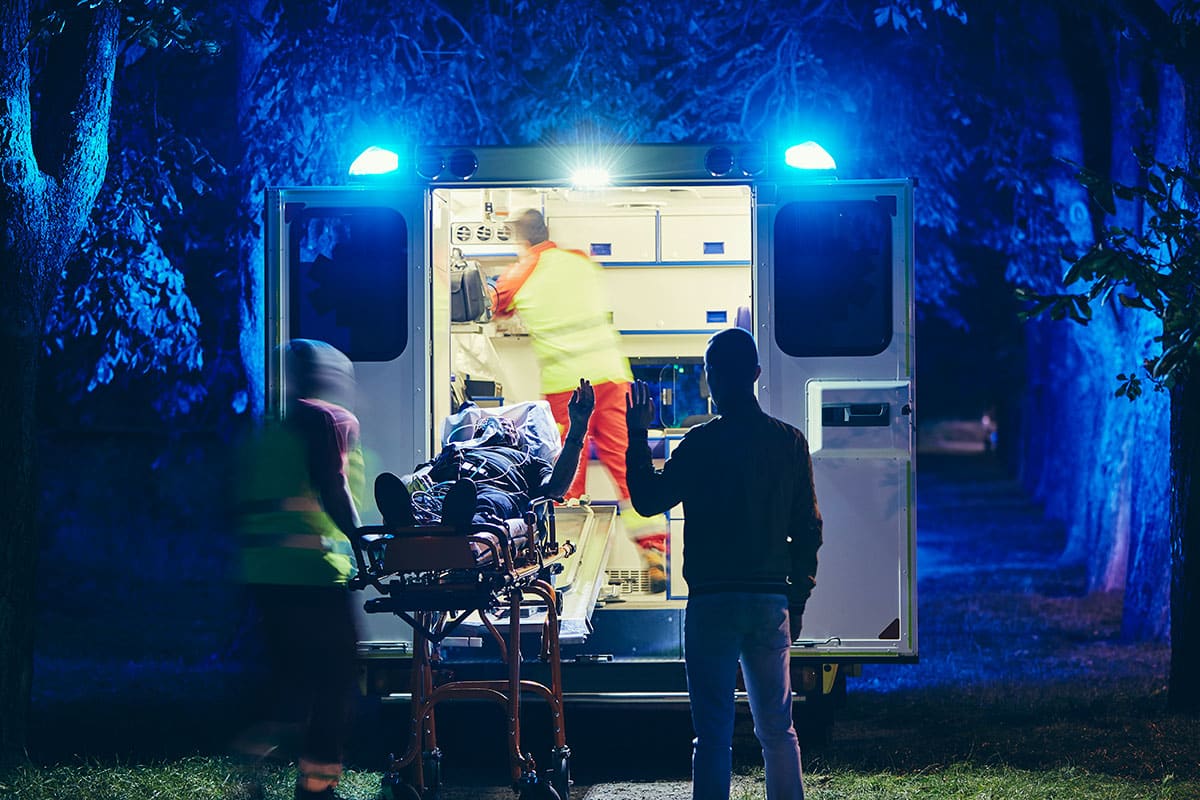 ambulance takes a person away while they wave that they're going to be ok