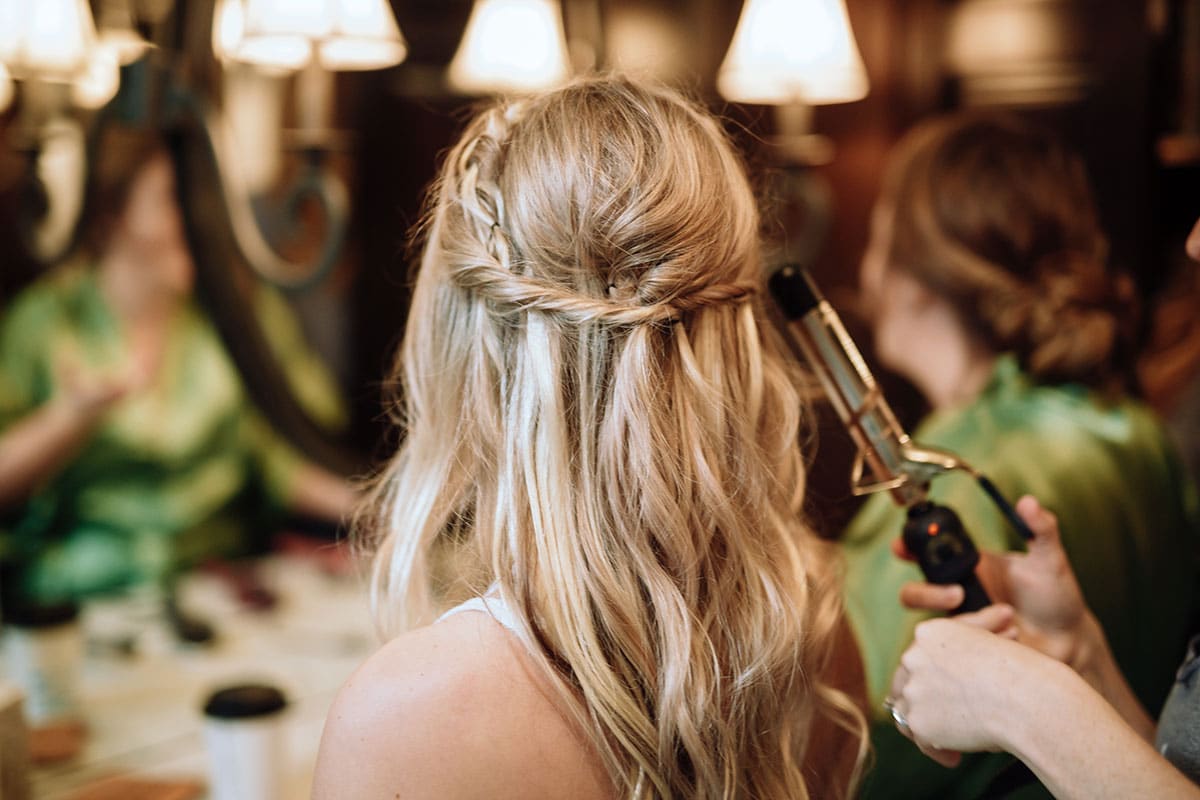 image showing the back of a womans head as she gets her hair curled at the salon