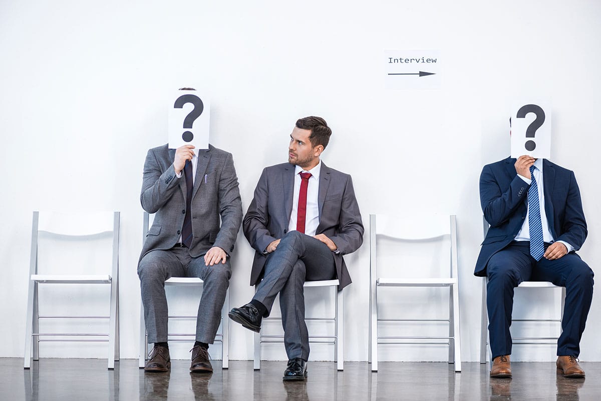 man waiting for an interview knowing he'll get the job because he knows more than everyone else