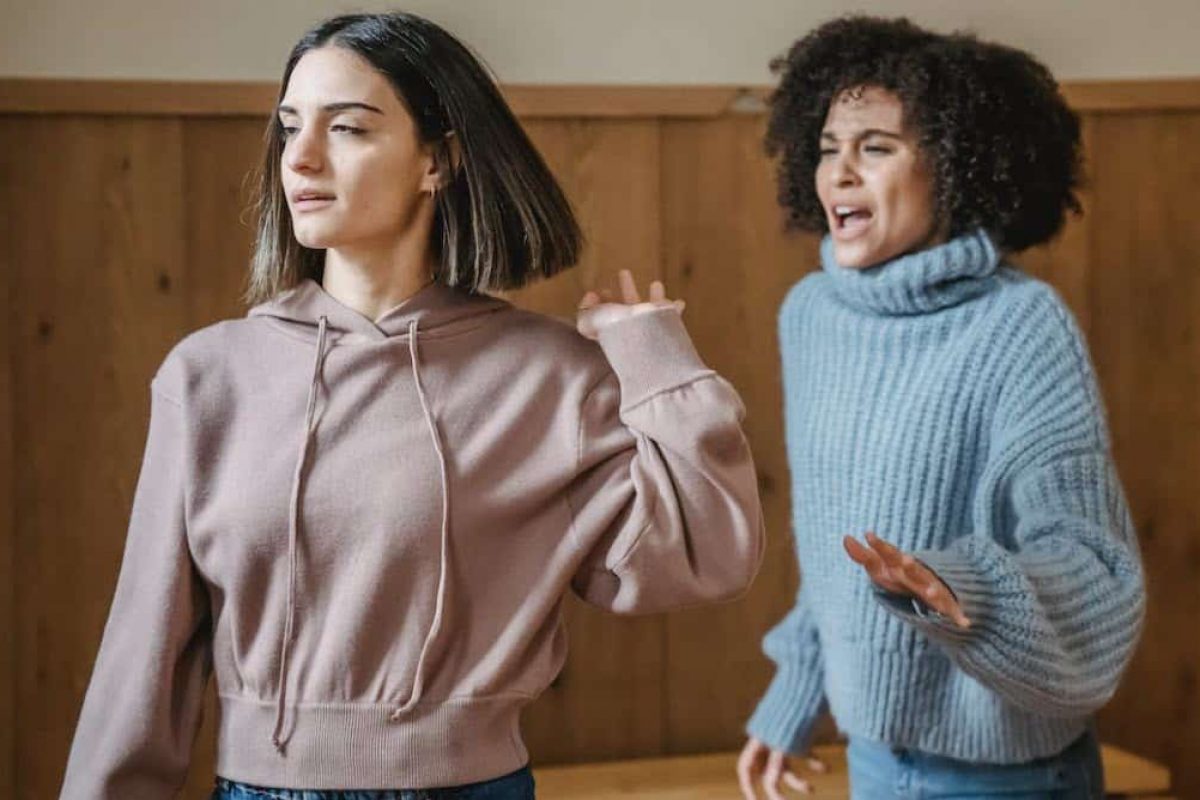 two women arguing while one walks away