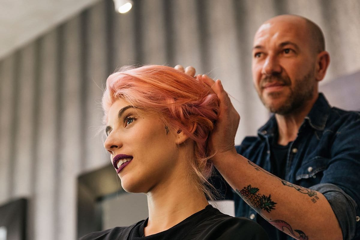 beautiful woman at hairdresser thinking of excuses for cutting your hair short