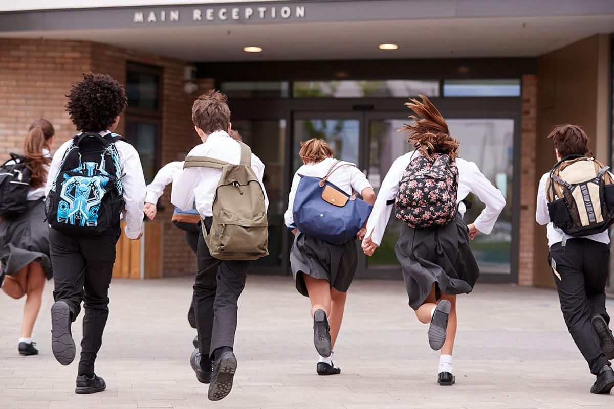 children running to school armed with excuses for wearing the wrong uniform